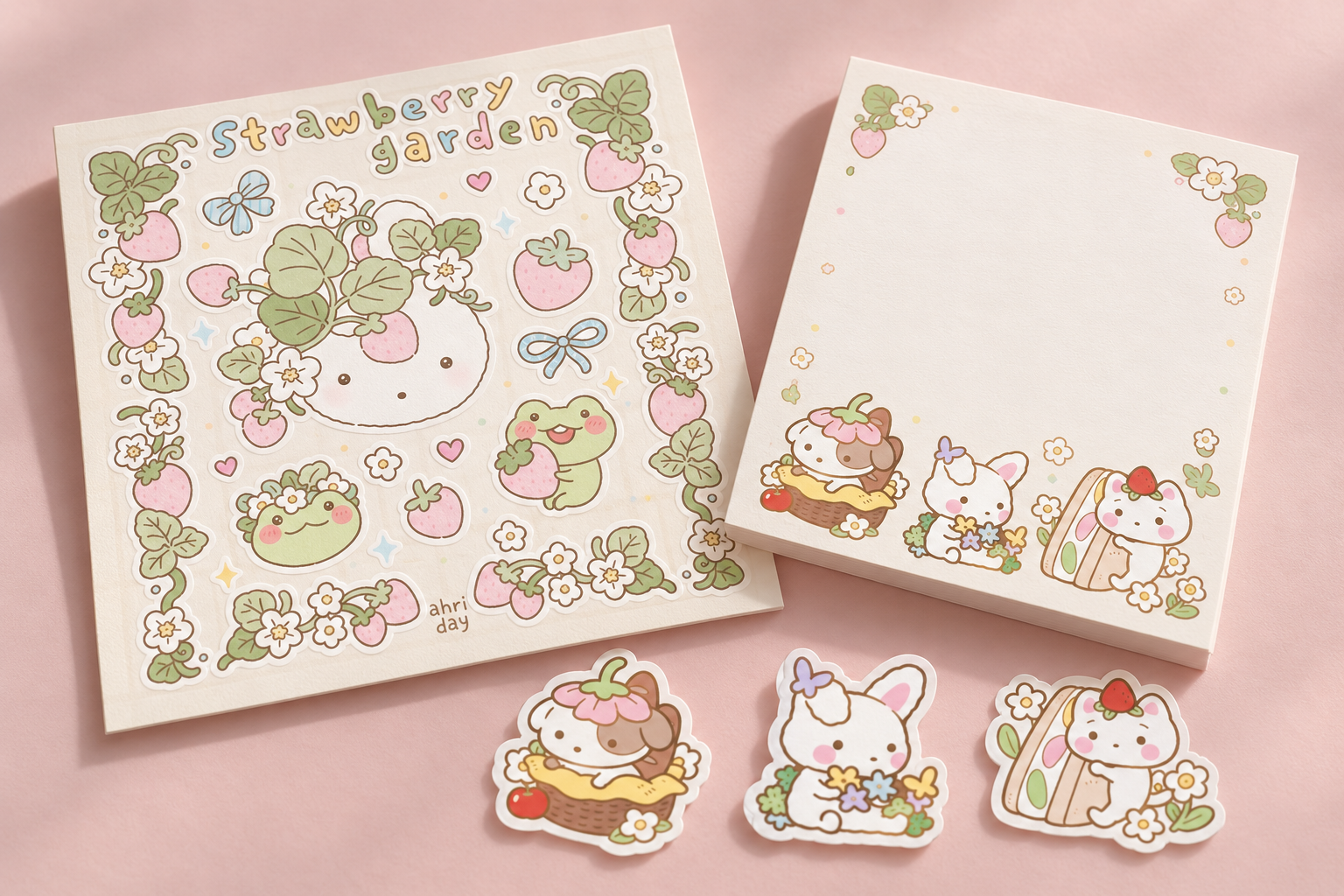 Concept product mockup of a Strawberry Garden sticker sheet, character stickers, and a memo pad