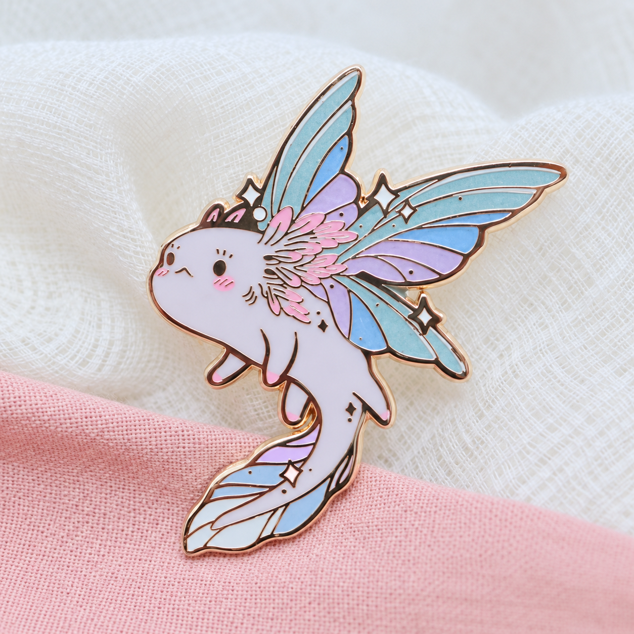 Pastel winged axolotl enamel pin; enhanced photograph of the finished product